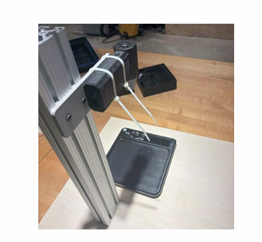 The assembled blower test rig: an aluminum extrusion mast holding a mini-turbofan blower above a fixed test surface