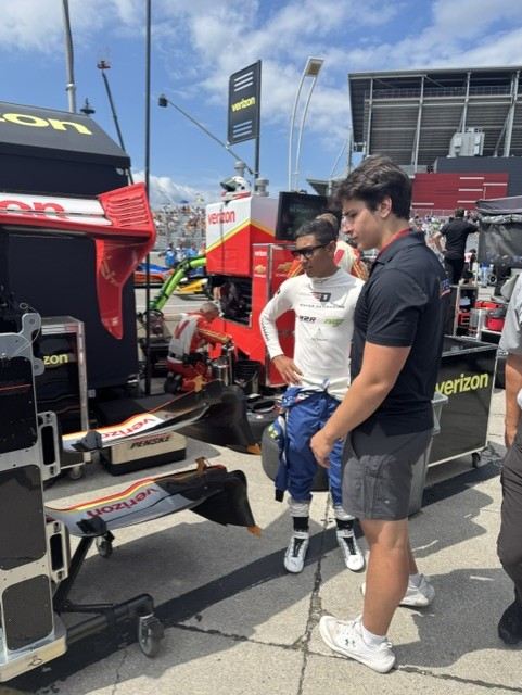 Ben and his driver in a focused conversation beside the pit equipment