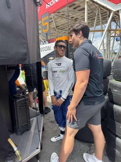 Ben and his driver beside the tire stacks in the IndyCar paddock
