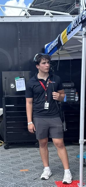 Ben on the radio headset in the Rysport Racing paddock before the race